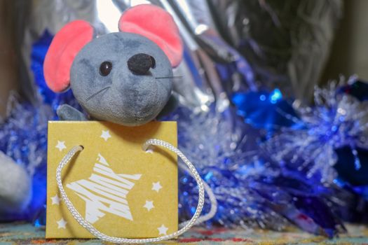 Blue plush mouse sitting in a bag. High quality photo