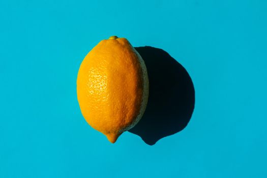 lemon with a hard shadow on a plain background. the view from the top. blank for the pattern. High quality photo