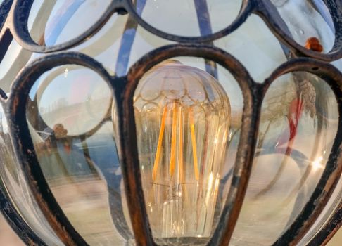 lamp with incandescent lamp close up as background. High quality photo