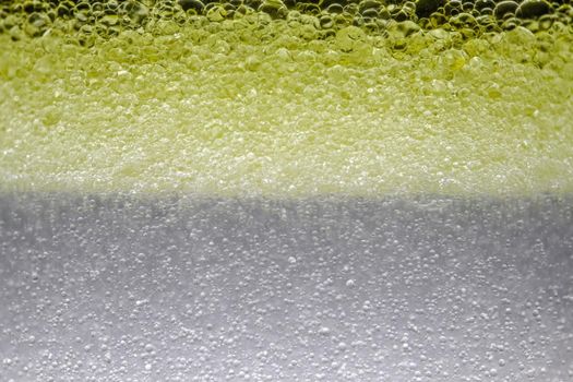 bubbles in yellow micellar water as background. High quality photo