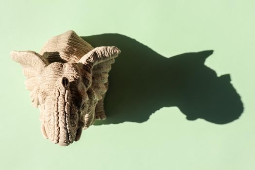 elephant statuette with a hard shadow on a plain background. the view from the top. blank for the pattern. High quality photo