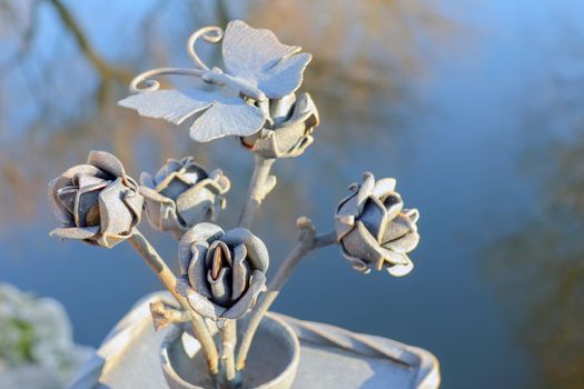 flower with a butterfly made of metal. High quality photo