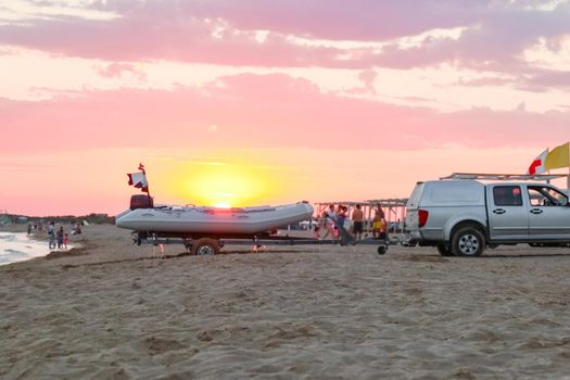 transporting a motor boat out of the water on the beach. High quality photo