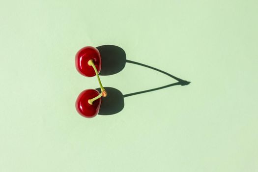 cherry berry with a hard shadow on a plain background. the view from the top. blank for the pattern. High quality photo