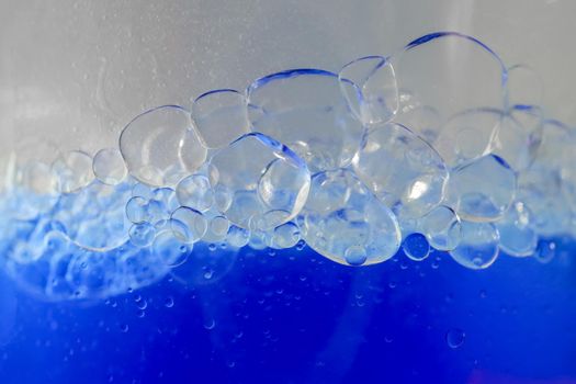 blue bubbles of micellar water macro as background. high-quality photos