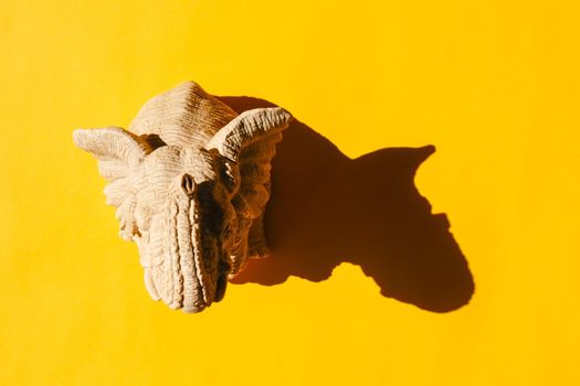 elephant statuette with a hard shadow on a plain background. the view from the top. blank for the pattern. High quality photo