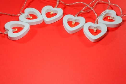 garland of hearts on a red background for Valentine's day. High quality photo