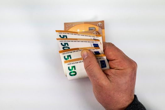man hand counting 50 euro bills on white background