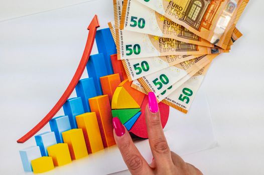 statistics chart with 50 bills and woman hand making victory symbol over white background