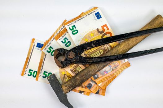 50 euro bills with work tools on white background