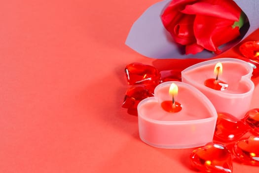 pink candles in the form of a heart on a red background for Valentine's day . High quality photo