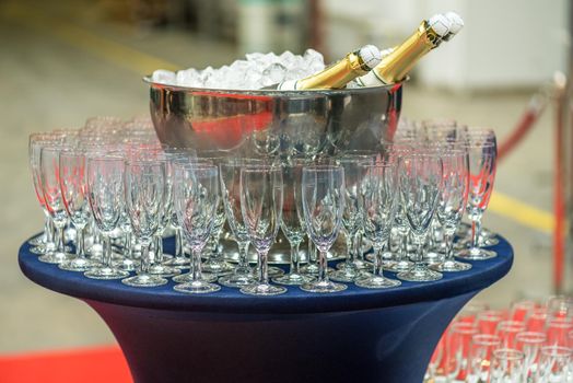 Bottle of champagne in bucket of ice.