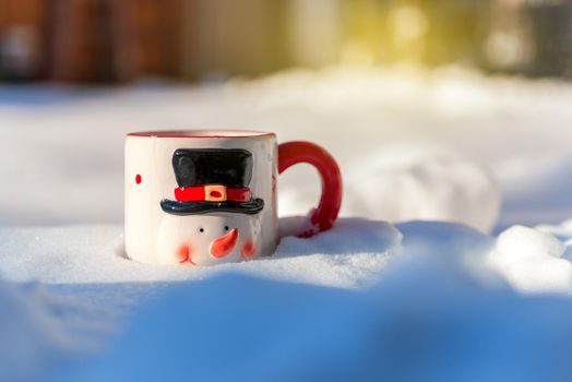 Christmas cup of a snowman in beautiful winter day