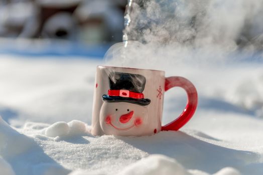 Christmas cup of a snowman in beautiful winter day