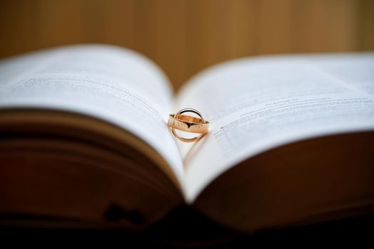 Wedding rings on a book