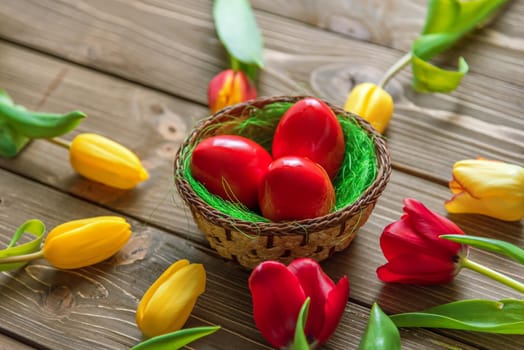 Tulips and easter eggs on vintage wooden