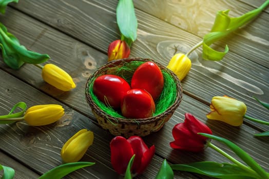 Tulips and easter eggs on vintage wooden