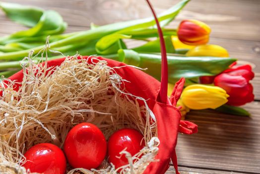 Tulips and easter eggs on vintage wooden