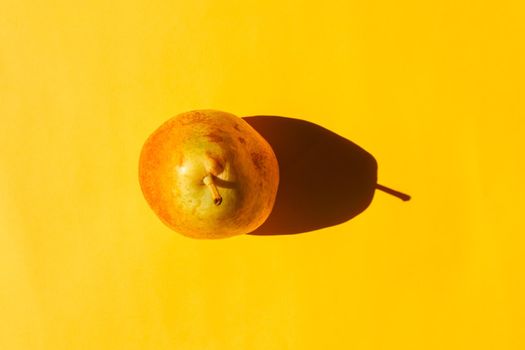 pear with a hard shadow on a plain background. the view from the top. blank for the pattern. High quality photo