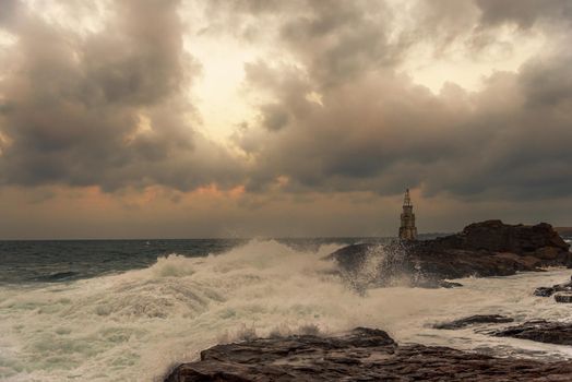 Stormy cloudy day. Dramatic sky and huge waves at the Lighthouse, Ahtopol, Bulgaria.