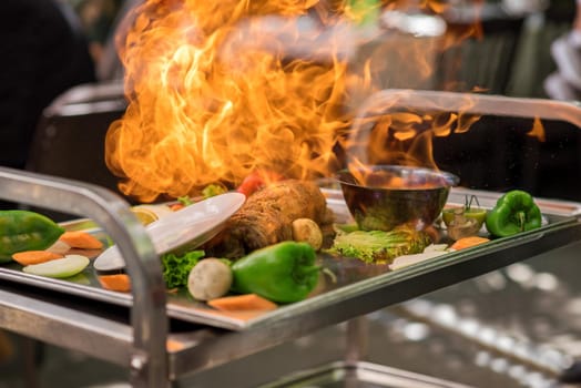 Grilled meat /steak with vegetable on the flaming grill