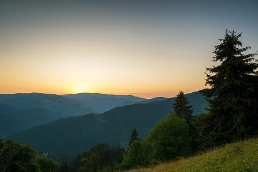 Panoramic view of colorful sunrise in mountains in summer.