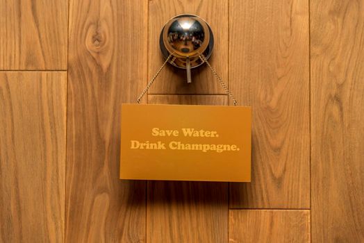 Wooden background with plate. Save water. Drink Champagne.Concept for the sale of wood