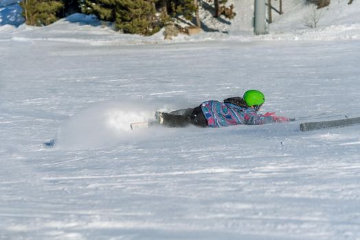 boy skier falling obliquely in winter days