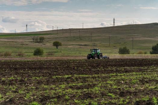 Tractor plowing fields. Preparing land for sowing in autumn.