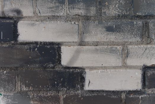Abstract white, black and gray painted brick wall as background, texture