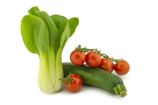 Chinese cabbage, green zucchini and cherry tomato twig isolated on white background