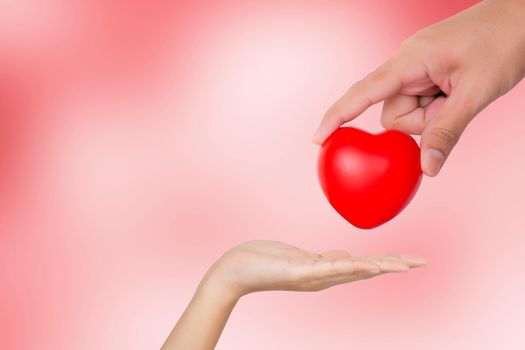 Hand of man giving red heart shape to woman, valentine day and love, relationship and romance, charity and volunteer, donate and donor, emotion and faith, help care, support and affectionate.