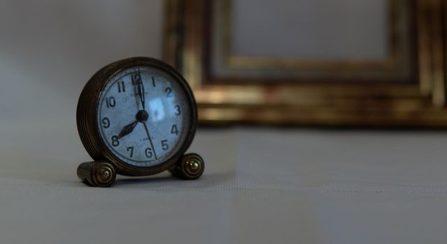 Vintage clock with white background and gold frame