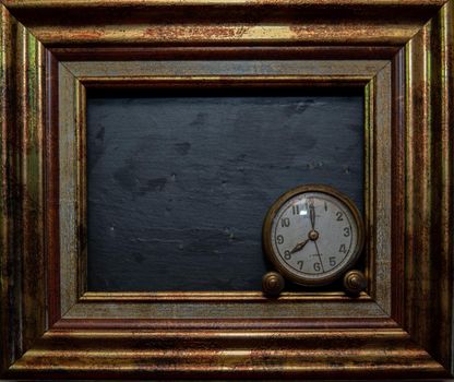 Vintage clock on black slate background and in marking