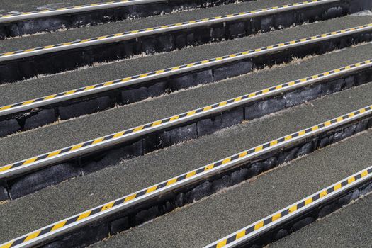 full frame background of roofing felt stairs with striped aluminium corners in diagonal perspective composition.