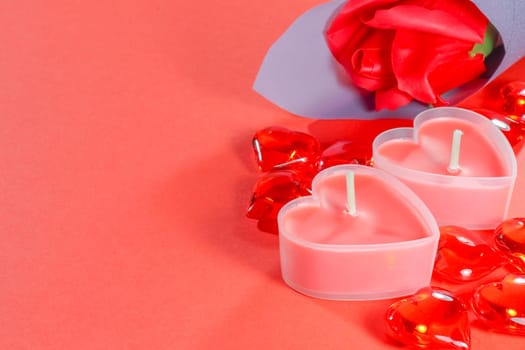 pink candles in the form of a heart on a red background for Valentine's day . High quality photo