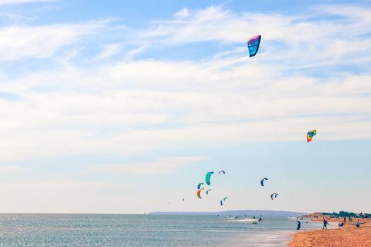 a kitesurfer surfing on the smooth azure water. recreational sport. A Man Rides A Kiteboarding In The Sea Water. extreme sport. High quality photo