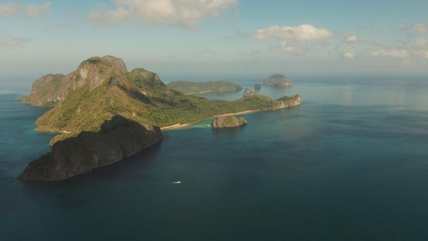 Seascape with tropical bay, rocky islands, ocean blue water, aerial view. islands and mountains covered with tropical forest. El nido, Philippines, Palawan. Tropical Mountain Range