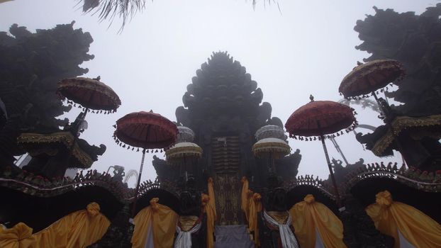 Hindu temple gate in the fog, Ulun Danu Batur, Bali,Indonesia. Balinese Hindu Temple, old hindu architecture, Bali Architecture, Ancient design. Travel concept.