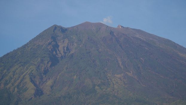 Agung, mountain, mountains covered with green forest, trees with sky and clouds. Slopes of the mountains are covered with forest in Asia. Bali,Indonesia. Travel concept.