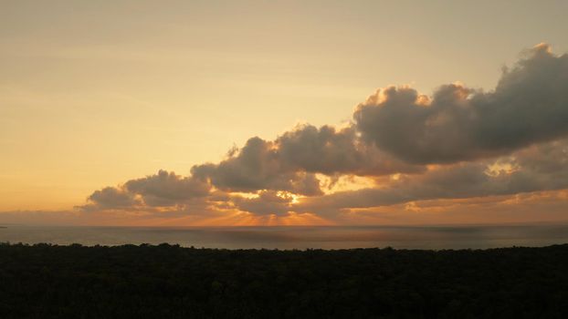 Morning sky with clouds during sunrise. Sunrise above the sea surface with waves, aerial view. Balabac, Palawan, Philippines. Sunrise over ocean.