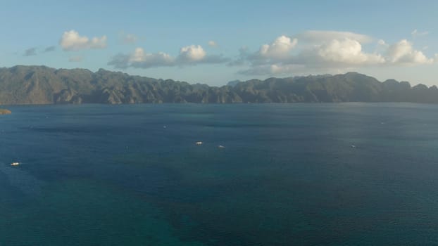 aerial seascape bay with islands and mountains covered with tropical forest at sunset. Palawan, Philippines. landscape with sea bay and mountain islands