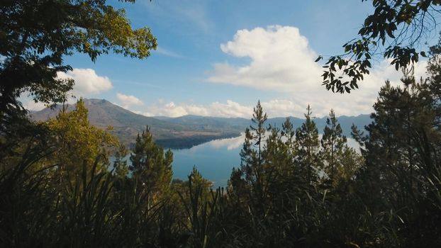 Aerial view Mountains, volcanoes, crater lake Batur, Bali, Indonesia. Mountain landscape with volcanoes, lake, sky and clouds. Travel concept