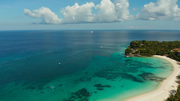 Sandy beach with blue water at tropical resort top view, Boracay, Philippines. Seascape with beach on tropical island. Summer and travel vacation concept.