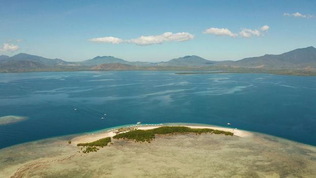 Island with sandy beach in the honda bay top view. Tropical island and coral reef with tourists. starfish island. Summer and travel vacation concept, Philippines, Palawan