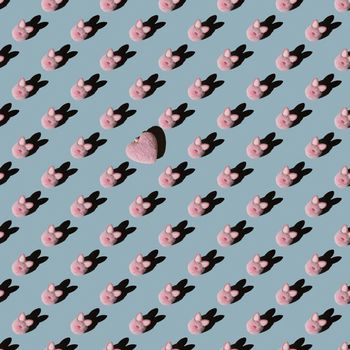 Easter pattern, pink bunny on a blue background. Flat composition with decorative hearts.