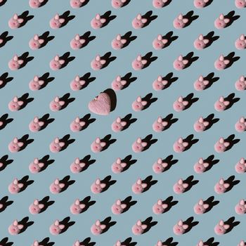 Easter pattern, pink bunny on a blue background. Flat composition with decorative hearts.