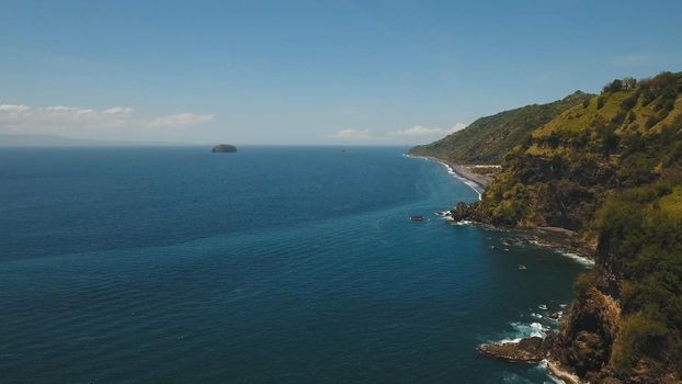 Aerial view sea coast, ocean, mountains, sea, beach, sky, clouds. Bali, Indonesia Seascape with Seashore on the background of mountains