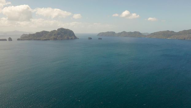 Aerial drone of Seascape with tropical rocky islands, blue water. islands and mountains covered with tropical forest. El nido, Philippines, Palawan