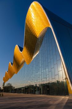 Moscow Russia-August 30, 2019 modern Palace of sports in rhythmic gymnastics close-up against the blue sky with the reflection of the sun in the glass walls
